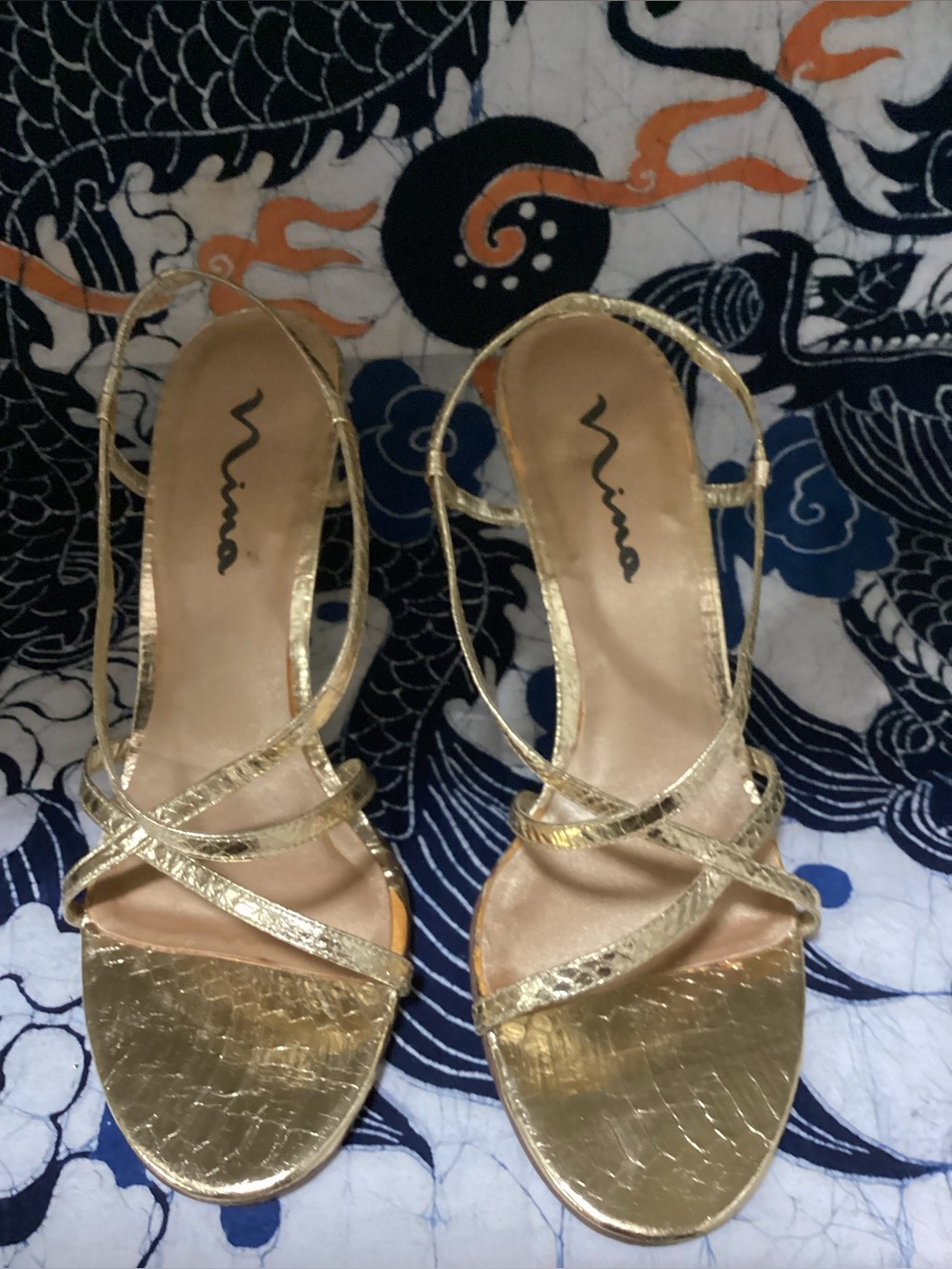 Women’s gold Nina heel sandals, featuring delicate ankle straps & stiletto heels